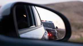 Police cruiser in car sideview mirror during a traffic stop