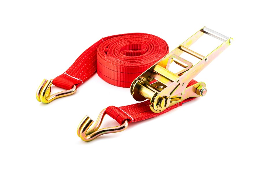 Red-orange ratchet strap with gold hardware on a white background