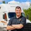 Truck driver Greg Swift pictured in front of a Schneider semi rig.