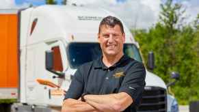 Truck driver Greg Swift pictured in front of a Schneider semi rig.