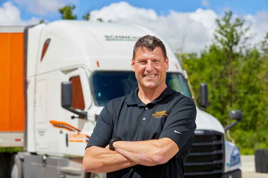 Truck driver Greg Swift pictured in front of a Schneider semi rig.