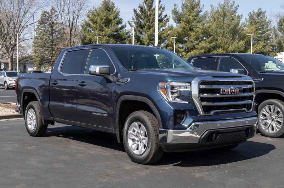 A dark blue 2022 GMC Sierra truck parked outside in right front angle view at a dealership lot