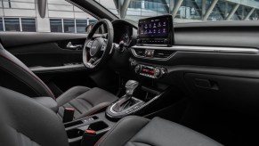 2022 Kia Forte sedan view of front black interior including steering wheel, instrument panel, seats, and shifter