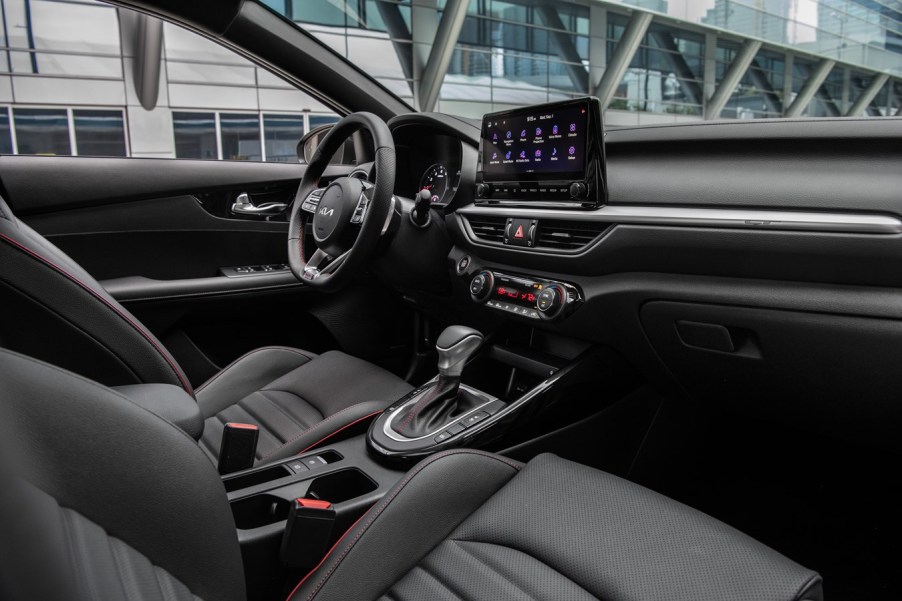 2022 Kia Forte sedan view of front black interior including steering wheel, instrument panel, seats, and shifter