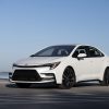 A white 2023 Toyota Corolla parked in left front angle view at a marina