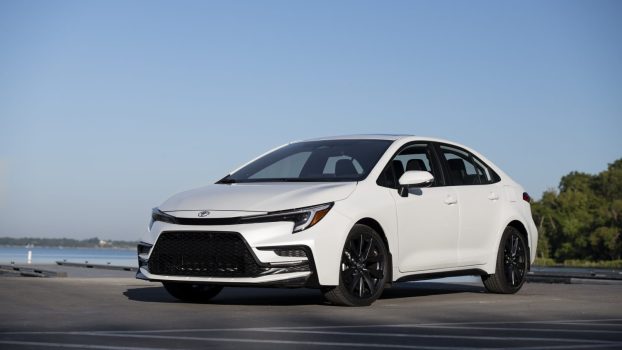 A white 2023 Toyota Corolla parked in left front angle view at a marina