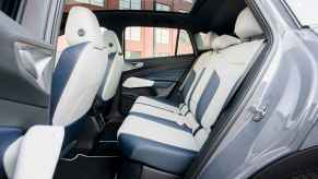 The left rear door of a 2023 VW ID.4 EV SUV open and showing the rear seats