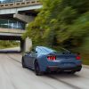 An S650 Ford Mustang GT driving on city streets.