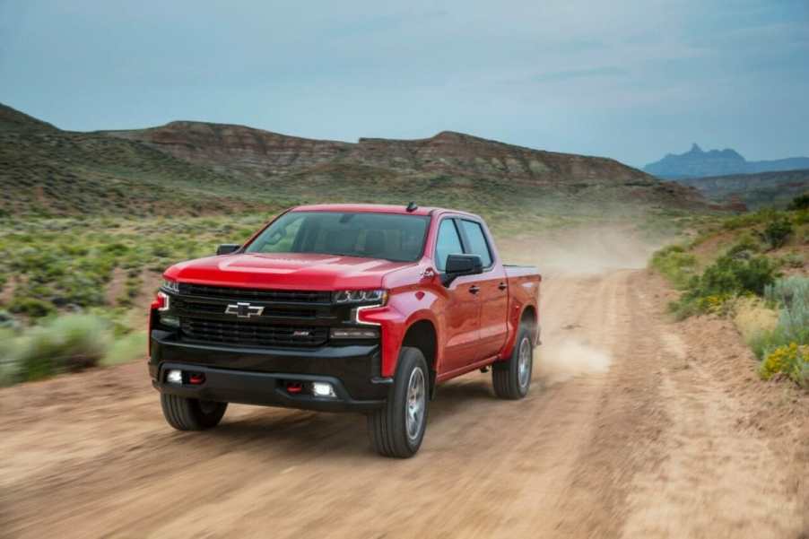 The 2025 Chevy Silverado 1500 driving down a dirt road