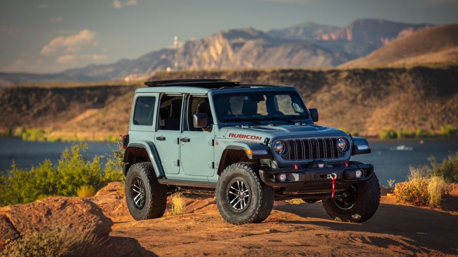 The 2025 Jeep Wrangler climbing over rocks