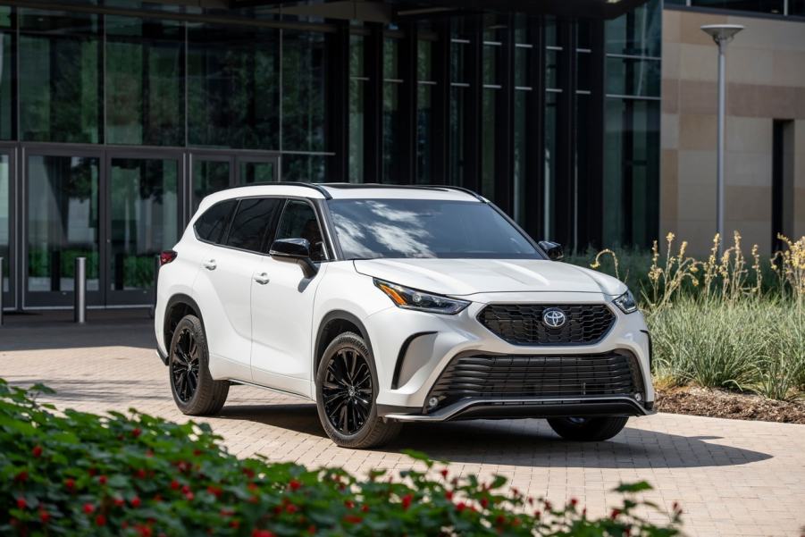 The 2025 Toyota Highlander parked near a home