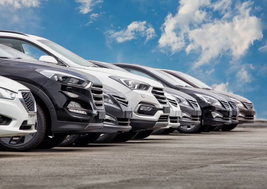 A row of new cars at a dealership for shoppers to use car-buying tips to shop.