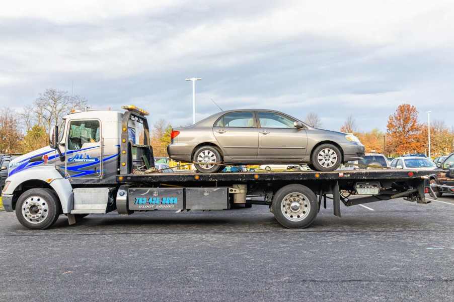 Car on a flat bed tow truck.