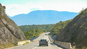 Lone car drives into croatia after a long roadtrip.