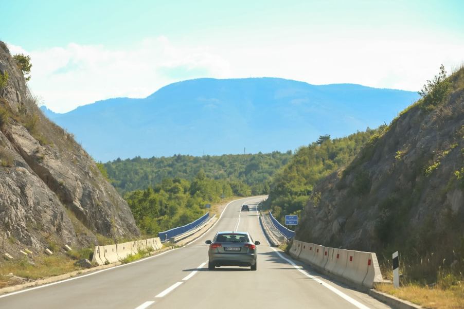 Lone car drives into croatia after a long roadtrip.