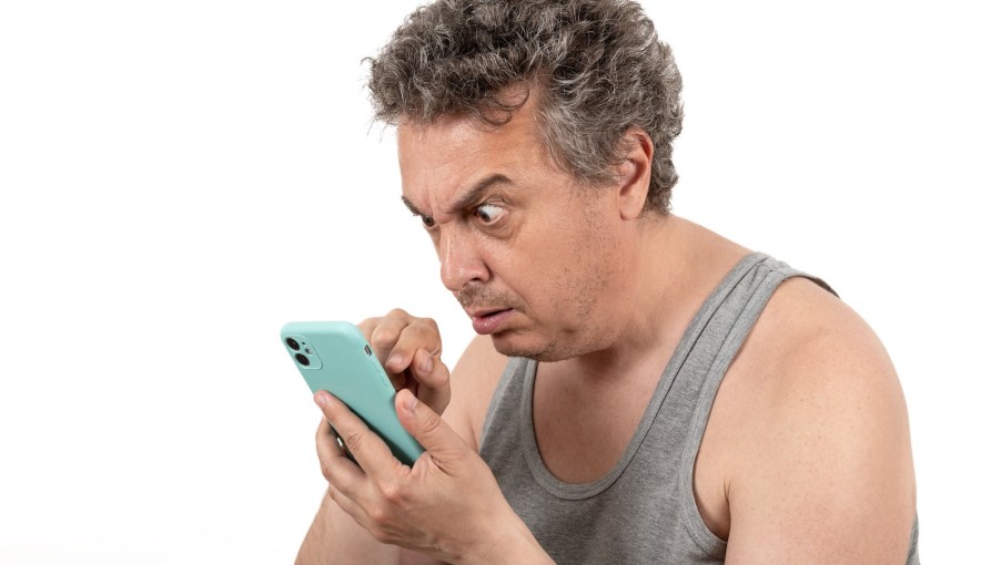 Grayhaired dad stares at a ringing cellphone.