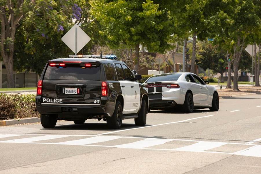 A Dodge Charger is pulled over by a police officer.