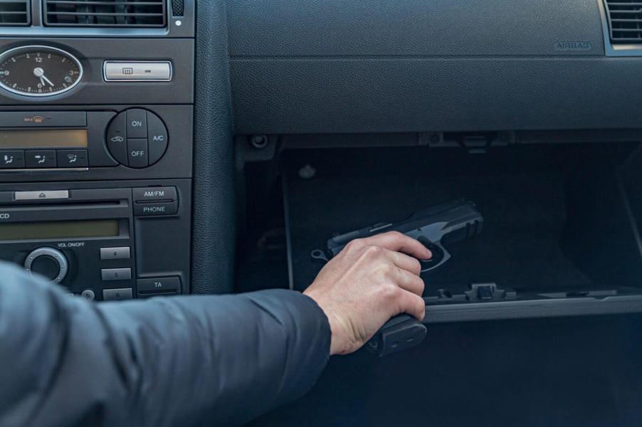 A driver reaches for a handgun replica in an episode of road rage.