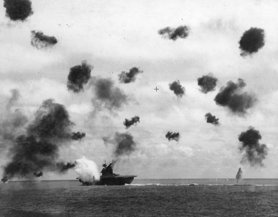 A US Navy ship, USS Yorktown, takes a hit at Midway during WWII.