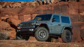 A gray Jeep Wrangler Rubicon on a hill.