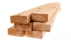 Wooden lumber boards stacked on a white background.