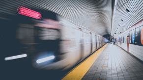 Train blurring by the platform in a New York City subway