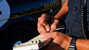 A police officer issues a written warning instead of a ticket at a traffic stop.