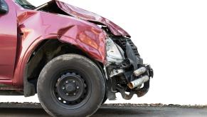 Front bumper of a red pickup truck, smashed by a crash.