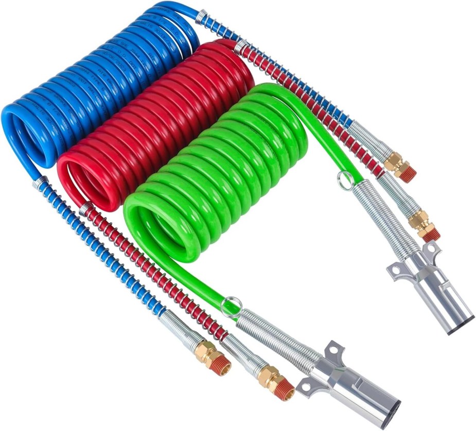 Blue, red, and green hoses to connect a semi truck and its trailer on a white background