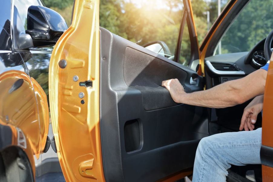 Pickup truck driver hangs foot out of cab to stop.