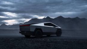 A Tesla Cybertruck shows off its angular styling under an overcast sky.