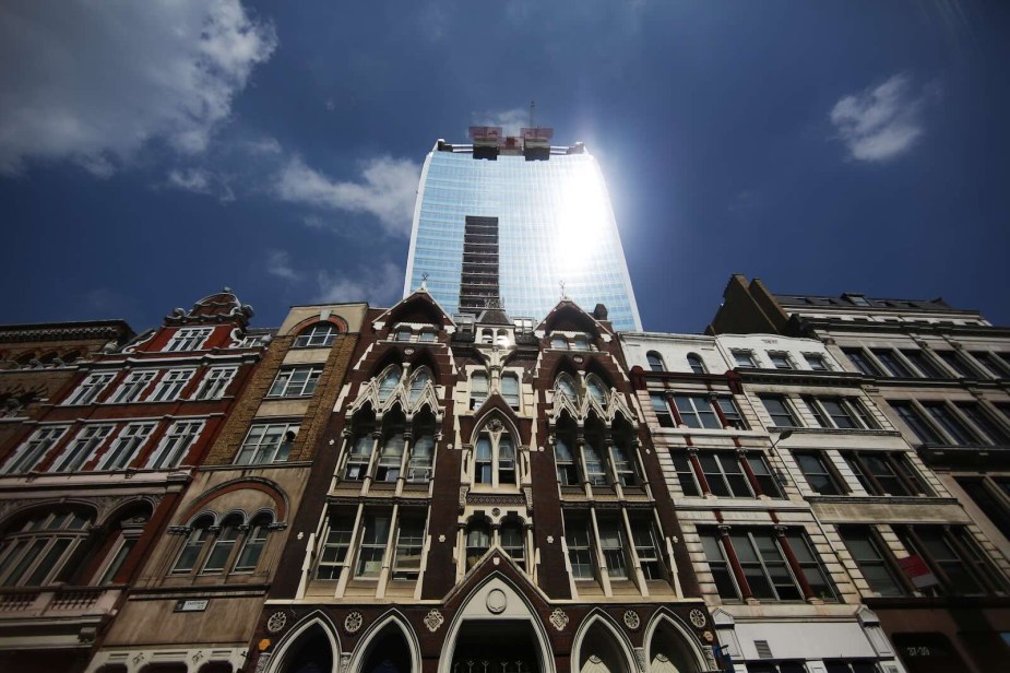 The sun glints off the concave "walkie talkie" building.