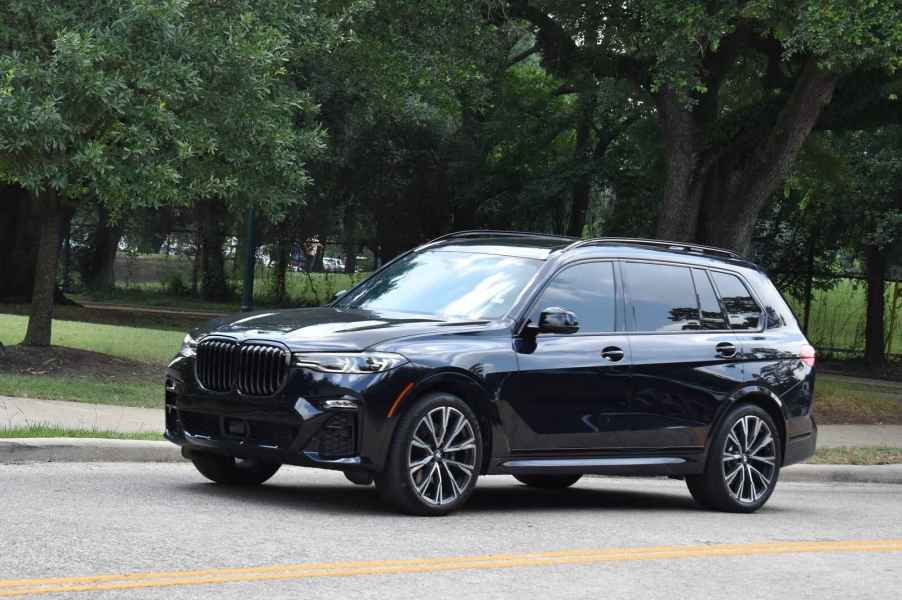 A black BMW X5 luxury SUV parked on a street in left profile view