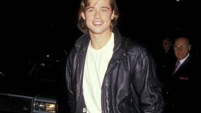 Brad Pitt photographed at night at Beverly Wilshire Hotel in Beverly Hills, California, wearing white t-shirt and black leather jacket in 1988