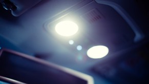 Photo of a vehicle's interior dome light illuminated at night.