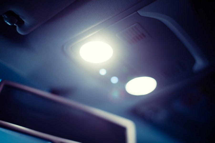 Photo of a vehicle's interior dome light illuminated at night.