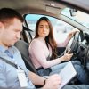 Teen looks concerned while a driving instructor fails her test