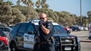 A police officer by a Ford Explorer police inceptor