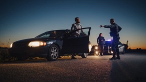 An officer telling a driver to exit their vehicle