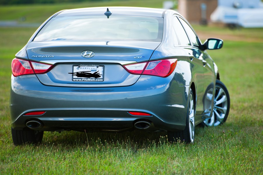 A 2011 Hyundai Sonata parked in grass