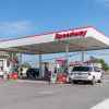 A Speedway gas station with two cars parked at pumps