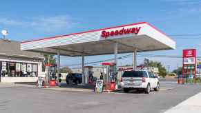 A Speedway gas station with two cars parked at pumps