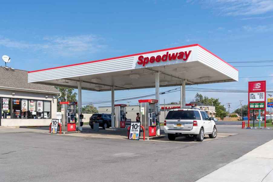 A Speedway gas station with two cars parked at pumps