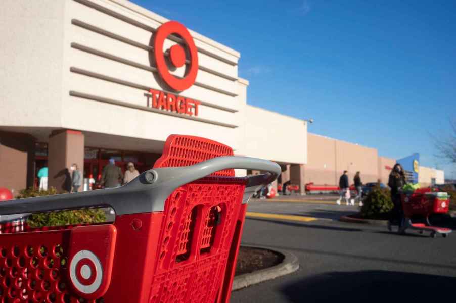 A view of a Target store exterior parking lot with red shopping cart in the foreground in close view