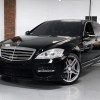 A black 2007 Mercedes-Benz S65 AMG parked in right front angle view in a showroom