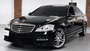 A black 2007 Mercedes-Benz S65 AMG parked in right front angle view in a showroom