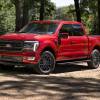 The 2024 Ford F-150 Hybrid off-roading in the woods