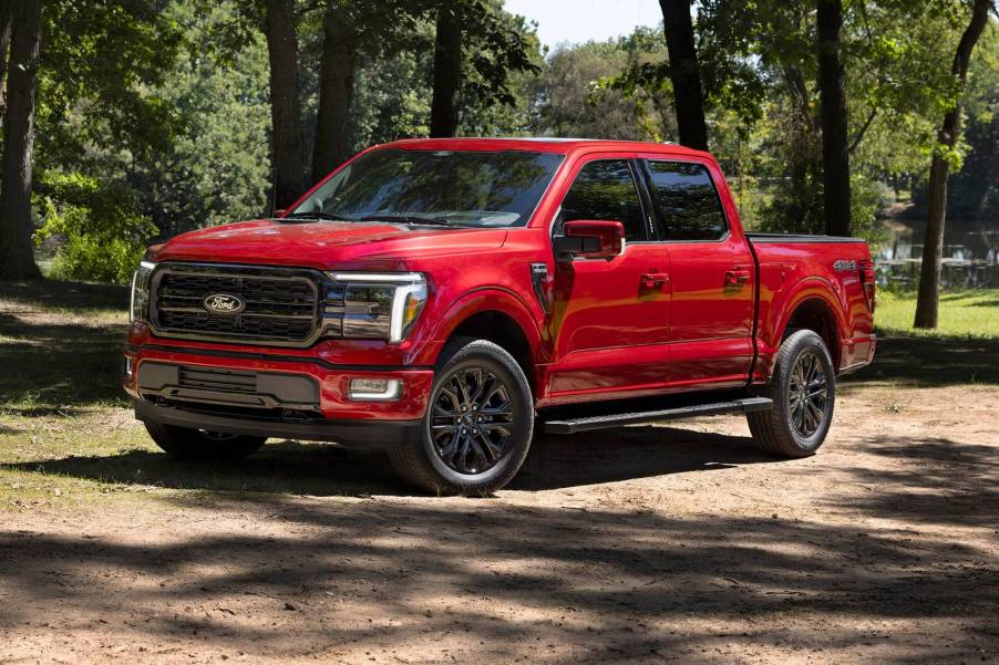 The 2024 Ford F-150 Hybrid off-roading in the woods