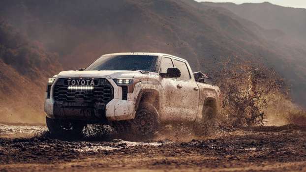 The 2024 Toyota Tundra Hybrid splashing through mud