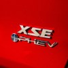 The PHEV badge on a red Toyota RAV4.